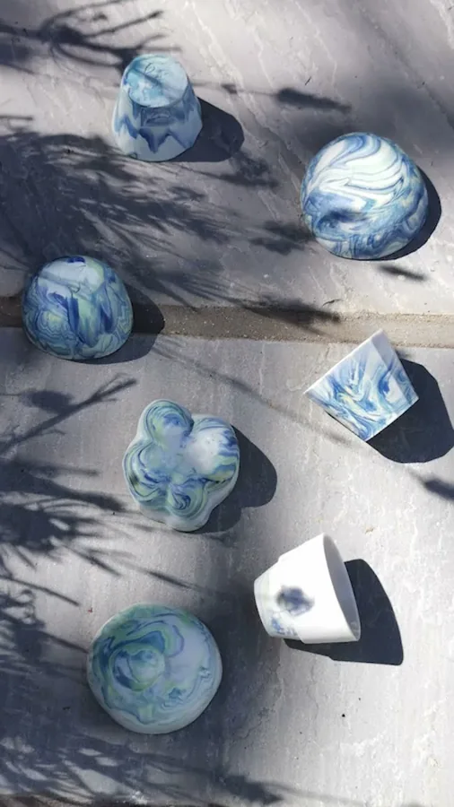 Video of blue and white marbled ceramic cups drying in the sun
