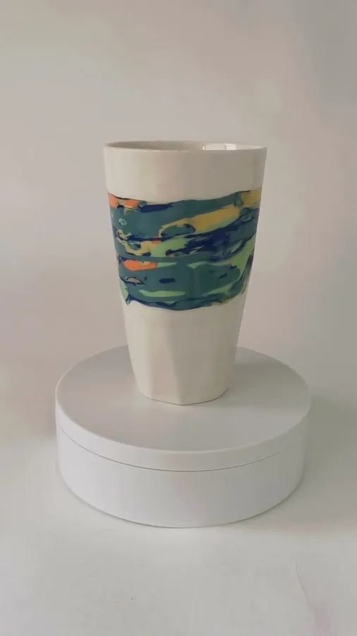 Video of a multicoloured ceramic vase turning on a plinth